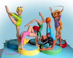 three figurines are posed in the shape of people doing different things on top of each other