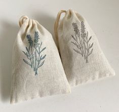 two bags with lavender flowers on them sitting next to each other