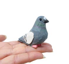 a small bird sitting on the palm of someone's hand