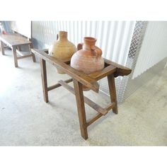 two vases sitting on top of a wooden table