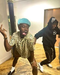 three young men are dancing in an empty room