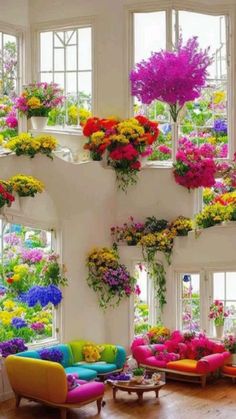 a living room filled with lots of colorful furniture and flowers hanging from the ceiling above