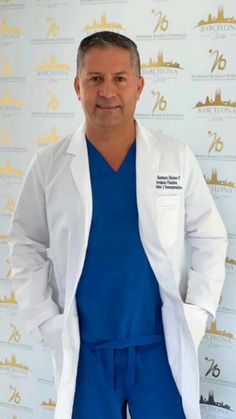 a man in scrubs standing next to a wall