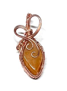 One of a kind, beautiful wire wrapped stones, set in pure copper. Orange Wire Wrapped Handmade Jewelry, Orange Copper Wire Jewelry As A Gift, Orange Copper Wire Jewelry For Gifts, Orange Copper Wire Wrapped Jewelry, Unique Orange Wire Wrapped Jewelry, Gold Copper Wire Jewelry With Gemstones, Wire Wrapped Amber Jewelry For Gift, Gold Gemstone Jewelry With Copper Wire, Elegant Brown Copper Wire Jewelry