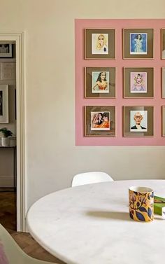 a white table with pictures on the wall