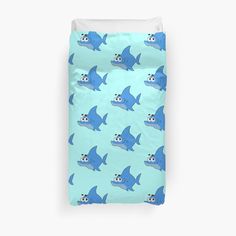 a bed with blue and white sharks on it