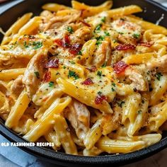 pasta with chicken and sauce in a black bowl