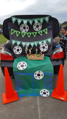 the trunk of a car is decorated with soccer decorations