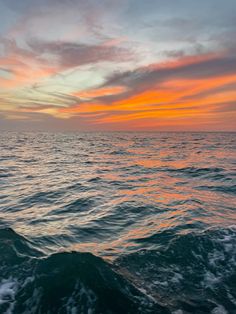 the sun is setting over the ocean as it reflects in the water's surface