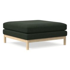 a green ottoman sitting on top of a wooden frame