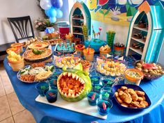 a blue table topped with lots of food