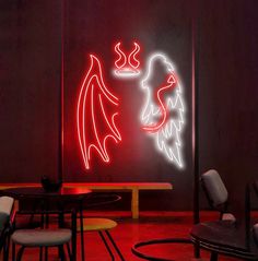 two neon lights are lit up on the wall above a dining room table and chairs