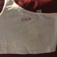 Very Cute Women's One-Shoulder Tank Top With Pink Levi’s Logo 92% Cotton 8% Elastane Casual One-shoulder Crop Top For Summer, Casual Cropped One Shoulder Top For Summer, Casual White One-shoulder Crop Top, White One-shoulder Crop Top For Summer, White Cotton One Shoulder Top For Spring, Casual One-shoulder Crop Top For Spring, Trendy Cotton One Shoulder Top For Summer, Trendy Levi's Summer Tops, Summer Trendy Levi's Tops