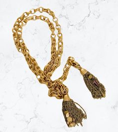 Our Davin can be worn several ways but is just begging to be layered! Gorgeous textured double link chain in a stunning satin gold tarnish resistant finish. 3” tassels with crystals on one side and coins on the other embellish the ends. Chain Measures 40” but you have options on length. It can be tied, worn doubled around the neck, or clipped to hold it in place. (clip included). Gold Tassel Dangle Necklace, Gold Metal Jewelry With Tassels, Gold Metal Tassel Jewelry, Chic Gold Tassel Jewelry, Chic Gold Jewelry With Tassels, Gold Lariat Tassel Necklace, Gold Tassel Lariat Necklace, Gold Tassel Necklace With Adjustable Chain, Gold Tassel Necklace With Fringe For Gift