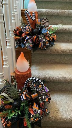 a set of stairs decorated for halloween with pumpkins, candy canes and decorations