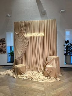 a stage set up for an event with drapes on it