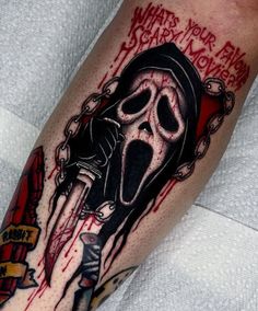 a man's arm with a skull and knife tattoo on it