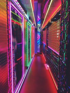 a long hallway with neon lights on the walls