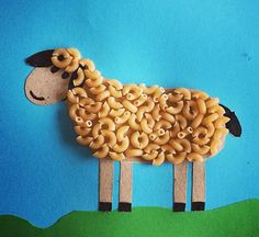 a sheep made out of pasta on a blue background