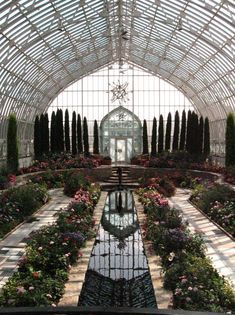 the inside of a building with lots of flowers in it