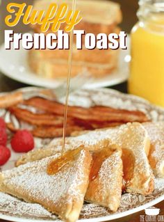 french toast on a plate with strawberries, raspberries and orange juice in the background