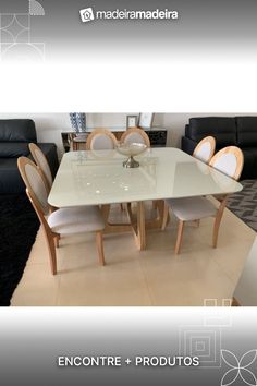 a glass table with chairs around it in front of a black couch and white rug