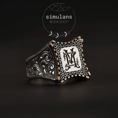 Elevate your style with this custom initials sterling silver men's ring, meticulously handcrafted with detailed engravings. This 925 sterling silver ring features a unique design where the customizable initials are elegantly set in a bronze bezel. The ring showcases exquisite hand-engraved patterns, making it a standout piece for any occasion. Materials: 925 Sterling Silver, Bronze Design: Customizable initials on a silver plate, set in a bronze bezel Customization: Personalize with your initial Luxury Silver Initial Ring, Luxury Silver Initial Ring Hallmarked, Luxury Silver Hallmarked Initial Ring, Luxury Engraved White Gold Initial Ring, Sterling Silver Rings With Engraving Option, Custom Silver Engraved Ring, Vintage Silver Monogram Engraved Ring, Vintage Silver Monogram Rings, Sterling Silver Initial Ring For Formal Occasions