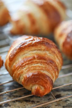 some croissants are cooling on a rack