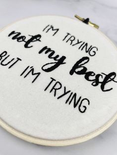 this is an embroidered hoop with the words, i'm trying to be best but i'm trying