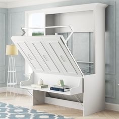 a white bed with a book shelf underneath it