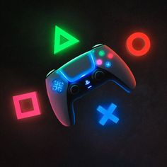 a video game controller glowing in the dark with neon colors on it's side