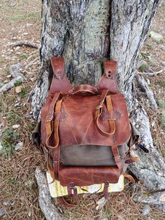 It's a professionally handcrafted Leather backpack for travelers. It's 2mm(5 oz) vegetable-tanned leather. I use it for camping and trekking,hiking. Embrace the wilderness in style with this handcrafted leather backpack, built for adventure. Features More than just a bag, it's your companion on the trail, crafted with premium waxed cotton and designed for ultimate comfort and functionality. Two roomy front pockets keep essentials close at hand, while the dedicated axe hanger with buckle secures Brown Waxed Canvas Bag For Camping, Leather Backpack With Waxed Finish For Outdoor Activities, Leather Backpack With Waxed Finish For Outdoor, Leather Backpack For Hiking With Waxed Finish, Waxed Leather Backpack For Hiking, Waxed Finish Leather Backpack For Hiking, Hiking Backpack With Waxed Finish, Rugged Leather Backpack For Outdoor Activities, Brown Backpack For Camping