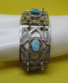 Un Worn vintage Egyptian revival turquoise ceramic stone scarab silver tone metal sectional panel bracelet with ornate designs end chain has dangle Ankh Cross charm and J clasp. Length including clasp 8 inches. Width 7/8 inch. I offer combined shipping discounted charges. Handwritten Gifts, Pendant Watches, Metal Panels, Gifts For My Sister, Cross Charms, Flower Jewellery, Turquoise Stone, Amazing Jewelry, My Jewellery