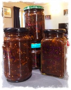 four jars filled with food sitting on top of a table