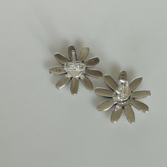 A PAIR of sun flower shaped sterling silver studs. Size: 13mm Weight: 2.2gm These earrings are made of 925 hypoallergenic sterling silver. All my pieces are sent in a gift box. I can include a personal message from you if needed. You are welcome to contact me at... bhavnakwintra1956@gmail.com More hoops: https://www.etsy.com/your/shops/TheSilverGame/tools/listings/section:26305414 More earrings: https://www.etsy.com/your/shops/TheSilverGame/tools/listings/section:26308789 Ear climbers: https://w Formal Silver Earrings With Flower Charm, Silver Flower Clip-on Earrings, Silver Flower Clip-on Earrings In Sterling Silver, Silver Sterling Silver Flower Clip-on Earrings, Silver Flower Clip-on Earrings For Anniversary, Silver Flower-shaped Clip-on Earrings For Anniversary, Silver Flower Shaped Earrings For Anniversary, Silver Flower Earrings For Formal Occasions, Silver Pierced Flower Earrings For Formal Occasions