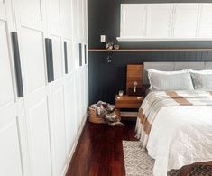 a bed sitting in a bedroom next to white closets