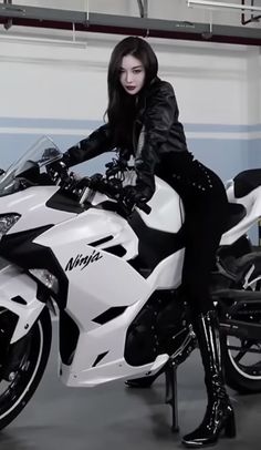 a woman sitting on top of a white motorcycle