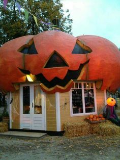 an orange pumpkin shaped building with two faces on it's roof