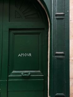 a green door with the word amovr written on it