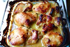 a casserole dish with chicken and gravy in it on a table