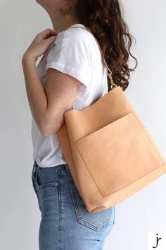 Natural vegetable tanned leather at its best! This handmade leather shoulder bag is relaxed and slouchy and is made from buttery soft undyed vegetable tanned leather that will darken and patina with age. Modern Leather Hobo Bag With Cell Phone Pocket, Leather Rectangular Bucket Bag With Cell Phone Pocket, Brown Everyday Hobo Bag With Cell Phone Pocket, Everyday Brown Hobo Bag With Cell Phone Pocket, Rectangular Leather Bucket Bag With Cell Phone Pocket, Chic Everyday Bucket Bag With Cell Phone Pocket, Everyday Rectangular Bucket Bag With Cell Phone Pocket, Chic Leather Hobo Bag With Cell Phone Pocket, Versatile Bucket Bag With Smooth Grain For Everyday Use