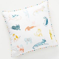 a white pillow with colorful animals on it