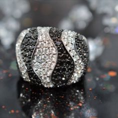 A ladies 18 karat white gold ring set with black and white diamonds in a zebra stripe design.  The total weight of all diamonds is 2.60 carats. Colored Diamond Jewelry, Diamond Fashion Rings, Wave Ring, Wave Design, Diamond Fashion, White Diamond, Diamond White, Colored Diamonds, Fashion Rings