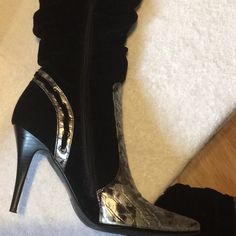 Black Boots With Silver Trim. Black Part Of Boot Is Not Leather, Similar To A Velvet Material. Sexy For A Skirt Or Jeans. I Bought These Boots In A Boutique In New York City And They Were Only Tried On In The Store. Never Worn. I Needed To Have Them Even Though They Were A Size 7 1/2 And I Am A 8. They Are An Eyecatcher Of A Boot. Metallic Fitted Heeled Boots With Pointed Toe, Metallic Fitted Boots For Formal Occasions, Fitted Metallic Elegant Boots, Chic Silver Heeled Boots For Night Out, Fitted Heeled Boots With Metal Feet, Metallic Fitted Boots For Night Out, Fitted Metallic Boots For Night Out, Silver Fitted Heeled Boots With Pointed Toe, Silver Fitted Heeled Boots For Winter