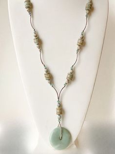 This gemstone necklace is aqua terra Jasper with a bold statement look! The subtle aqua color has areas f light cream. The round donut Jasper pendant bead is attached with sterling silver tube beads which add a look of movement. These are complimented by 6mm round erinite Swarovski crystals for a touch of elegance and sparkle. It closes with a very comfortable sterling toggle clasp. Your new necklace arrives in qlossy white box with a purple bow! Hope that you like it! Turquoise Aquamarine Necklace, Jade Gemstone Crystal Necklace With Round Beads, Bohemian Single Strand Jade Jewelry, Adjustable Turquoise Jade Necklace, Handmade Jasper Round Necklaces, Green Amazonite Necklaces, Round Turquoise Aquamarine Necklace, Turquoise Aquamarine Round Necklace, Earthy Jade Round Beads Jewelry