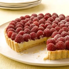 a raspberry cheesecake on a white plate