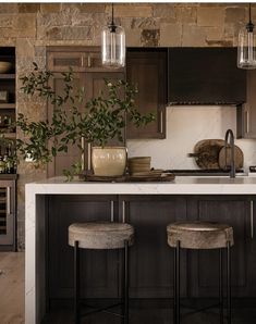 two stools sit at the center of a kitchen island