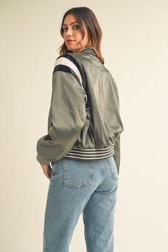 This Green Gray Cropped Satin Bomber Varsity Jacket is the ideal combination of style and warmth, perfect for any casual or formal occasion. Crafted with a luxuriously soft satin fabric and comfortable long sleeves, this jacket features attractive contrast color detailing that adds to its sophistication. The soft interior lining ensures maximum wearability and comfort. Fabric & fit: SELF: 92% POLYESTER 8% SPANDEXLINING : 100% POLYESTERCONTRAST: 96%POLYESTER 4%SPANDEX Model is wearing size Small. Best Fragrances, Satin Fabric, Formal Occasion, Contrasting Colors, Green And Grey, Varsity Jacket, Long Sleeves, Satin, Long Sleeve