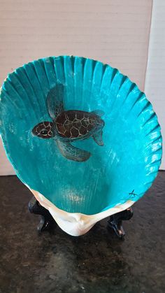 a blue bowl with a turtle painted on it