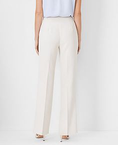 Elevate your wardrobe with the Ann Taylor Side Zip Trouser Pant in Fluid Crepe, tailored to accentuate your curves with elegance and style. These pants are meticulously designed to offer both comfort and a flattering fit.

- **Size:** 2
- **Color:** Ivory Whisper
- **Material:** 95% Polyester, 5% Spandex
- **Fit:** Curvy, tailored and fitted
- **Length:** Full length; 31 1/2" inseam, 21 1/4" leg opening
- **Rise:** High rise; sits 1/2" to 1" below natural waist
- **Leg Shape:** Trouser with a sl Elegant Straight Leg Bottoms With Zipper Closure, Fitted White Wide Leg Pants With Pressed Crease, Elegant Office Bottoms With Zipper Closure, Elegant Bottoms With Zipper Closure For Spring, Elegant Workwear Pants With Zipper Closure, Elegant Straight Pants With Zipper Closure, Chic Formal Bottoms With Side Zipper, Elegant Formal Bottoms With Zipper Closure, Elegant Straight Leg Bottoms With Zip Fly